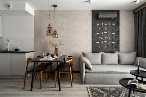a living room with a table and a couch at Apartamenty Podhale in Zakopane
