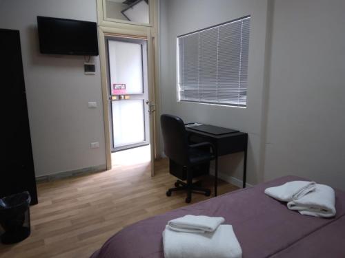 a bedroom with a bed and a desk and a computer at Bunker degli inventori in Foggia