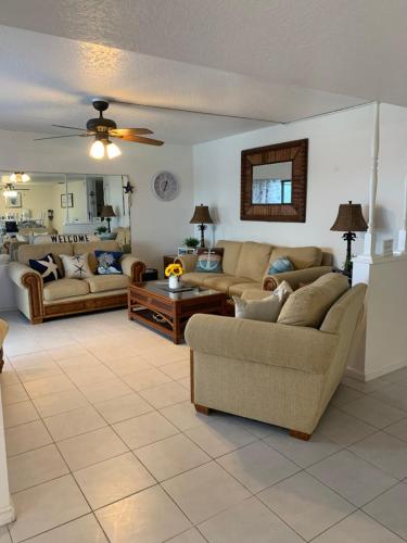 a living room with two couches and a table at Sea Club Condo #37 in Clearwater Beach