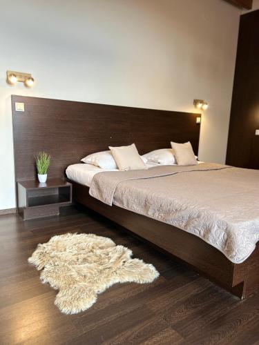 a bedroom with a large bed with a wooden headboard at AR GOLDEN HOUSE in Košice