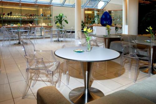 a restaurant with tables and chairs with flowers on them at AR GOLDEN HOUSE in Košice