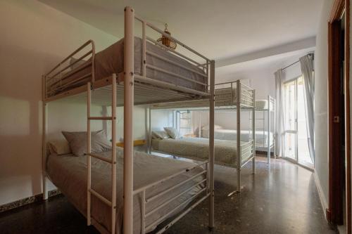 a bedroom with two bunk beds in a room at Casa del Abuelo Isla Canela in Isla Canela