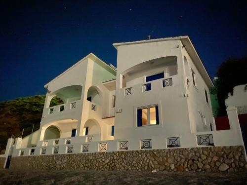a large white building at night at Aegean Aura Apartment II in Kalymnos