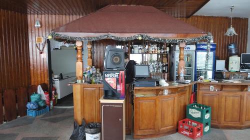 a bar with a tv on top of it at Семеен хотел Узана in Gabrovo