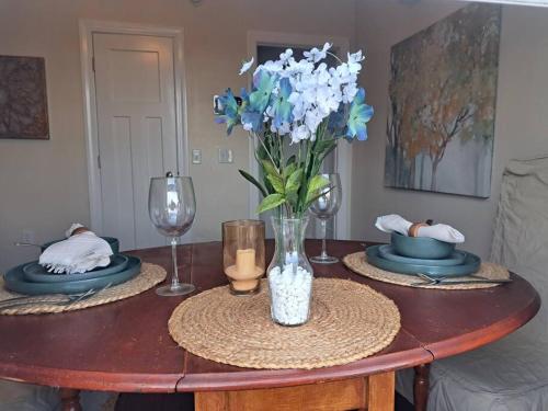 a table with a vase of blue and white flowers at Dunes Suite (Work Friendly) in Florence
