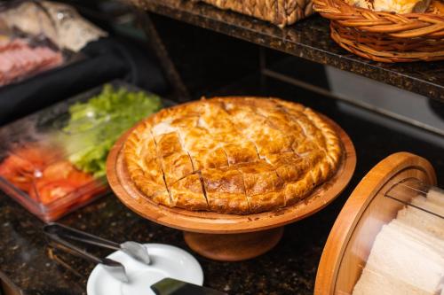 a pie on a wooden plate on a table at Howard Johnson Ciudad del Este in Ciudad del Este