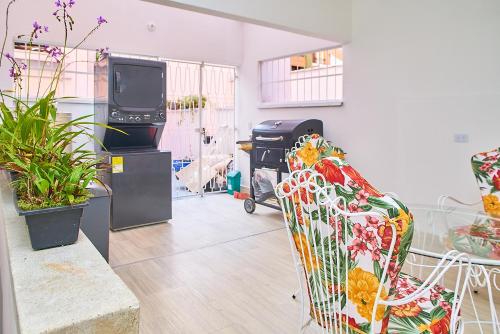 a living room with a couch and a tv at Hotel Boutique Fiorentina Medellín in Medellín