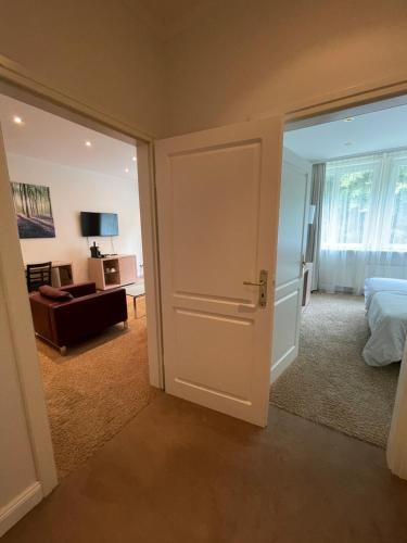 a bedroom with a door open to a room with a bed at Hotel Kieler Yacht-Club in Kiel