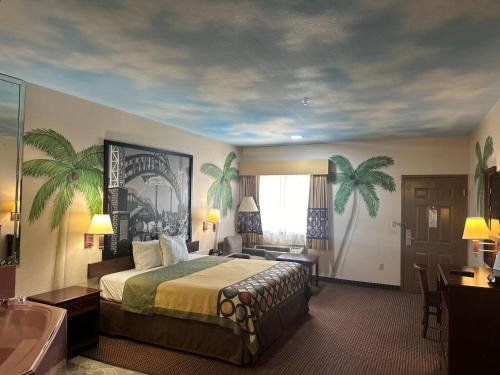 a hotel room with a bed and a bath tub at Belleza Inn & Suites Humble / FM 1960 in Humble
