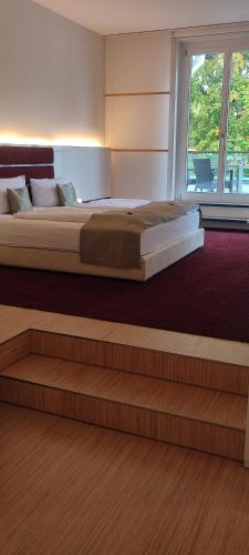 a bedroom with a large bed and a large window at Hotel Kieler Yacht-Club in Kiel