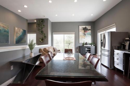 a kitchen and dining room with a table and chairs at Architectural Gem La Jolla Oceanview Surf And Golf in San Diego