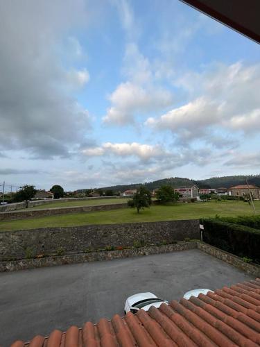 a view from the roof of a house with two chairs at Hotel Restaurante el Fornon in Novellana