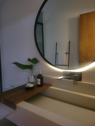 a bathroom with a sink and a mirror at CHALÉ NAMATA 201 in São Roque