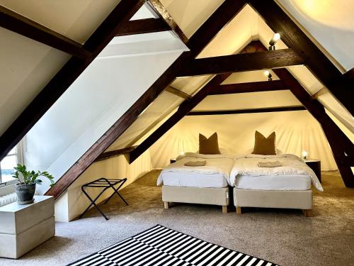 a bedroom with two beds in a attic at HARBOR HOUSE ZEELAND - nl in Goes