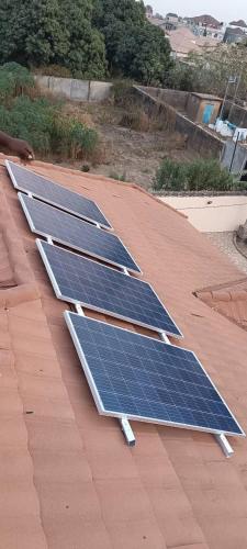 a group of solar panels on a roof at Laffie House in Sukuta