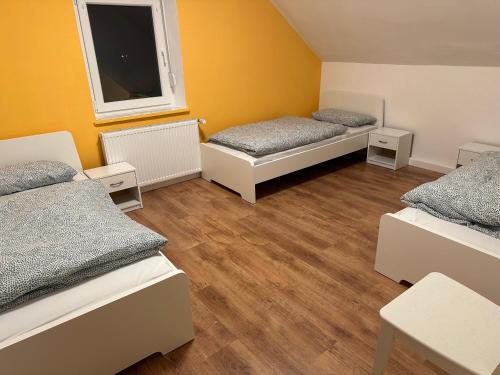 a room with two beds and a window at Anka´s Ferienhaus in Bexbach