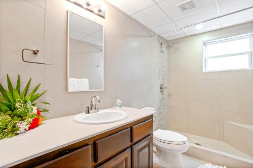 ein Badezimmer mit einem Waschbecken, einem WC und einer Badewanne in der Unterkunft Bananas On The Beach in San Pedro