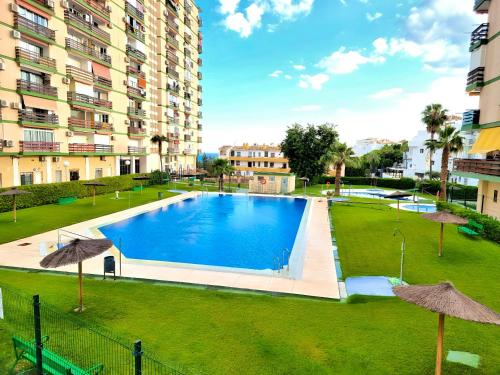 a swimming pool in a park with buildings at Elegant Studio with Sea View in Benalmádena - 30 m² in Benalmádena
