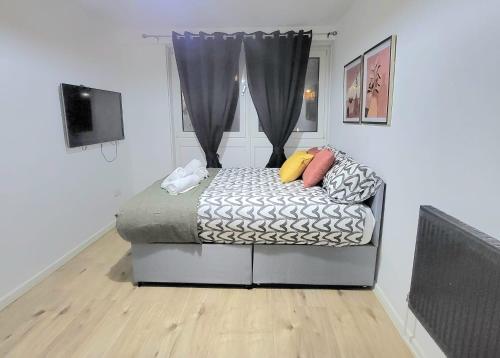 a bedroom with a bed and a window at Rooms close to QMUL in London