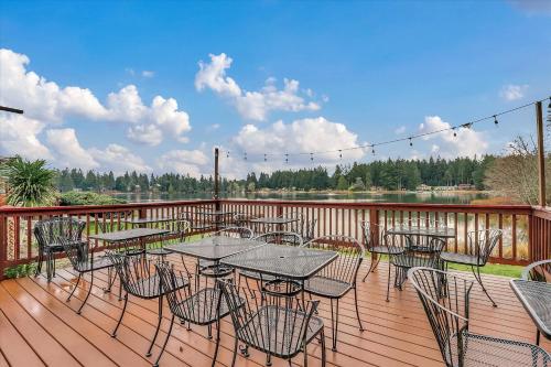 a patio with tables and chairs on a deck at Dogwood Place in Johnson Landing