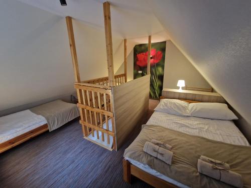 a room with two beds and a staircase in it at Willa Arga in Piwniczna-Zdrój