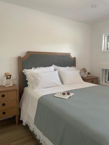 a bedroom with a bed with a tray on it at Casa do Cabo in Mós