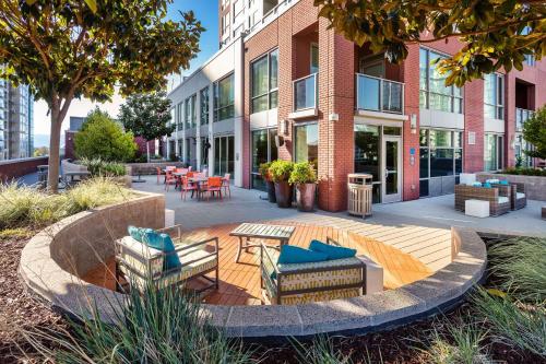 a patio with chairs and tables in front of a building at Global Luxury Suites San Jose Downtown in San Jose