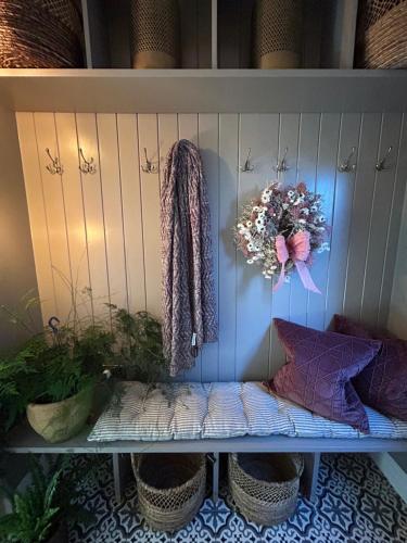 a shelf with sweaters and a wreath on it at The Lodge, Monkstown in Monkstown