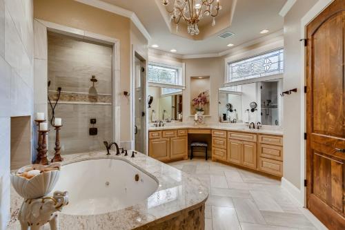 a large bathroom with a tub and a sink at * Luxury 4500 sf home* Pool Spa * near Lake Austin in Austin