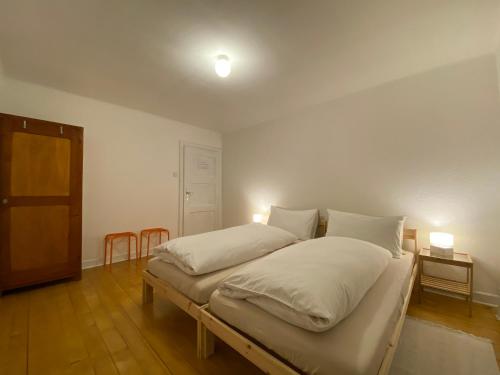 a bedroom with a large bed with white pillows at Pension Bellevue Gondo in Ruden