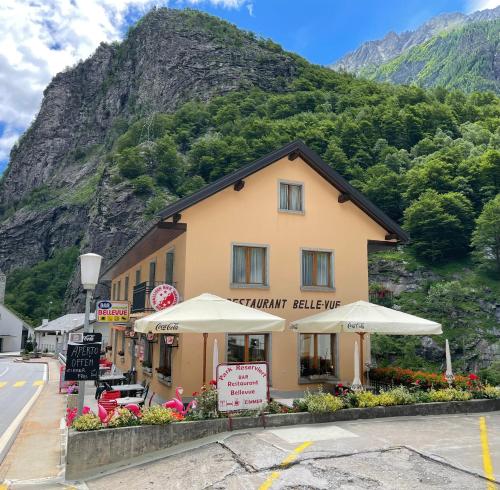 a building on a street with a mountain in the background at Pension Bellevue Gondo in Ruden