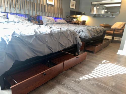 a bed sitting in a room with wooden drawers at Beautiful Condo Sleeps 4- Only 2 Blocks From Beach in Ocean City