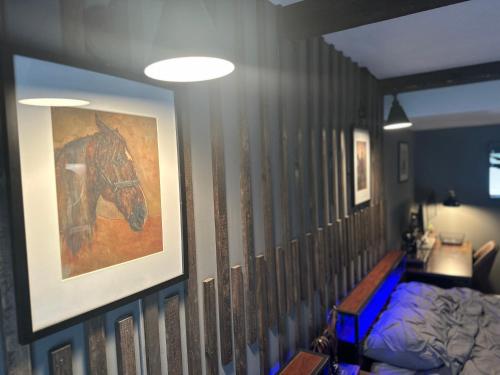 a bedroom with a painting of a horse on the wall at Beautiful Condo Sleeps 4- Only 2 Blocks From Beach in Ocean City