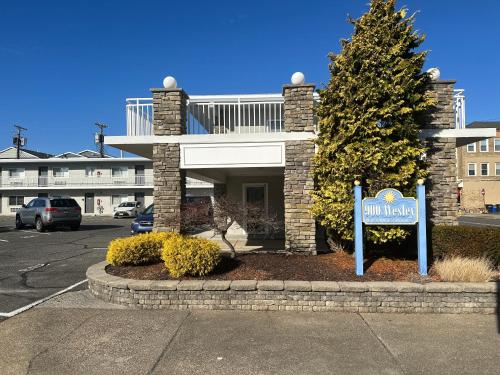 a building with a sign in a parking lot at Beautiful Condo Sleeps 4- Only 2 Blocks From Beach in Ocean City