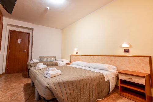 Ένα ή περισσότερα κρεβάτια σε δωμάτιο στο Hotel Zodiaco & Spa