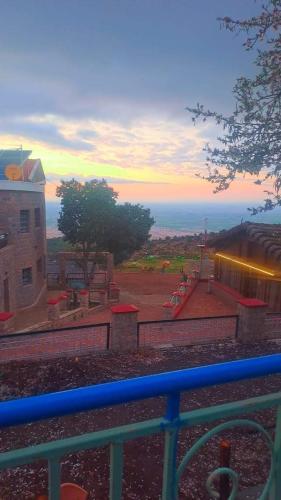 a view of a building with a sunset in the background at Chalet kaddoum in Beni Mellal