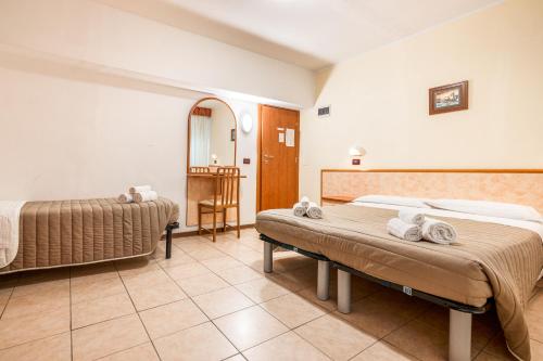 Ένα ή περισσότερα κρεβάτια σε δωμάτιο στο Hotel Zodiaco & Spa