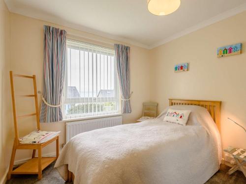 a bedroom with a bed and a large window at 3 Bed in Harlech 42153 in Harlech