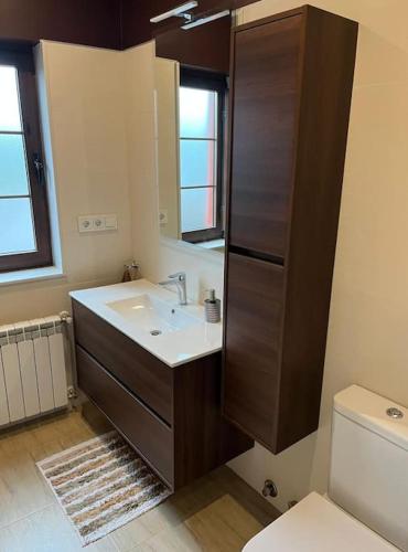 a bathroom with a sink and a toilet at La Casa del Marinero in Cudillero