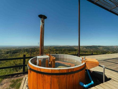 a wooden tub sitting on top of a wooden deck at Loft Increíble Vista y Jacuzzi Gratis, Único - 1A in Matanzas