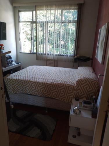 - une petite chambre avec un lit et une fenêtre dans l'établissement Apartamento aconchegante, à Rio de Janeiro