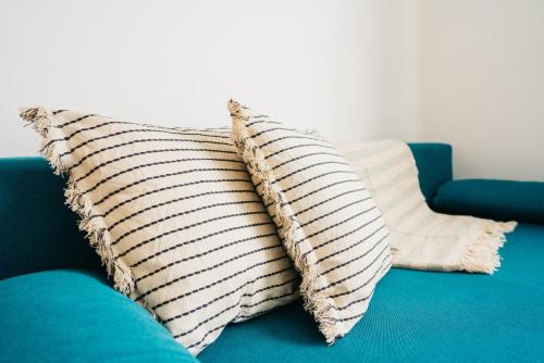 two pillows sitting on top of a blue couch at KAPINA sk - Dom Jasna in Liptovský Mikuláš