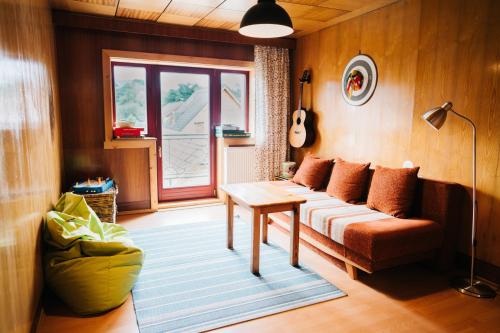 a living room with a couch and a table at KAPINA sk - Dom Jasna in Liptovský Mikuláš