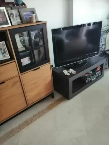 a living room with a television and a entertainment center at Cascais Luxury Top Floor Apt in Cascais