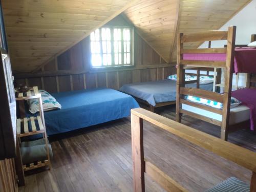 a bedroom with two bunk beds and a ladder at Casa do Campo in Ilha do Mel