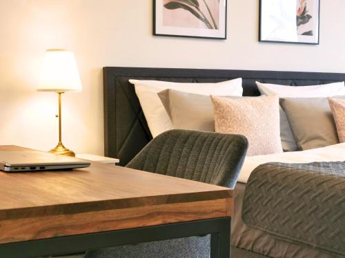 a bedroom with a table with a laptop on a bed at Fynbos Deluxe, Penthouse oder Balkon, Parkplatz in Straubing