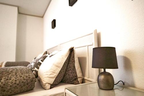 a lamp on a glass table next to a couch at Tripple Room with Bathroom. in Därligen