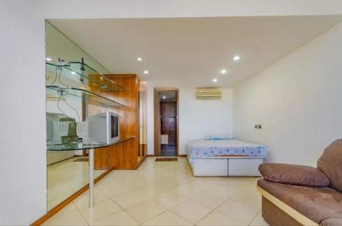 a living room with a couch and a bed at APT 1603 Sol Vitoria Marina Aluga a partir de 2 diarias entrar em contato numero do anfitrião esta abaixo ligar quarenta e oito horas antes, carnaval pacote 6 noite in Salvador