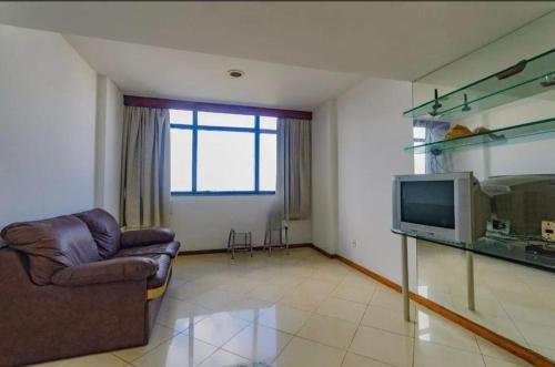 a living room with a couch and a television at APT 1603 Sol Vitoria Marina Aluga a partir de 2 diarias entrar em contato numero do anfitrião esta abaixo ligar quarenta e oito horas antes, carnaval pacote 6 noite in Salvador