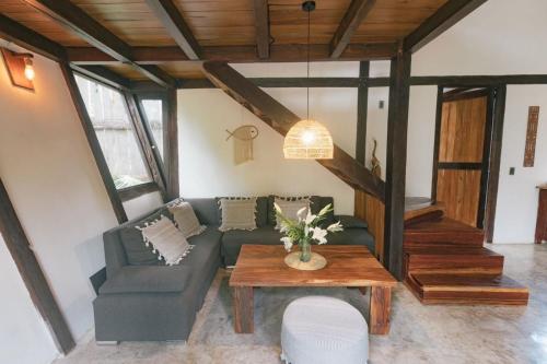 a living room with a couch and a table at Nahouse Jungle Lodges in Tulum